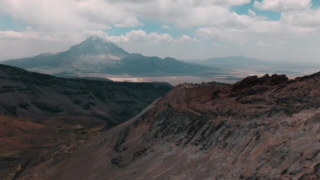 Aerial view of volcanic peaks, alpine lakes and rugged terrain in Sajama National Park, Bolivia. A remote high-altitude landscape in the Andes.