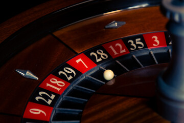 Refined wooden roulette wheel with lucky seven highlighted in a classic casino environment, illustrating gambling, risk and chance