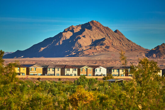 Desert Mountain Sunrise and Suburban Homes with Greenery in Henderson Nevada