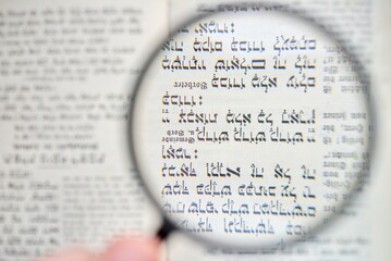 Magnifying Glass over Hebrew Script and German Schwabach Text
