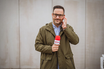 Reporter holding microphone presenting news broadcast live