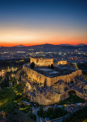 Fototapeta premium Aerial view of the illuminated Parthenon Temple at the Acropolis of Athens, Greece, during evening time