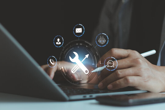 Businessman using laptop with digital support service interface, representing IT support, technical maintenance, customer service system, chatbot assistance and technology troubleshooting solutions.