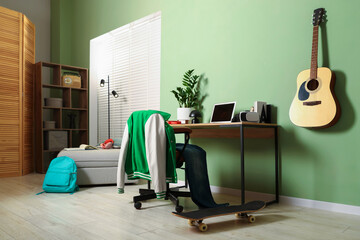 Stylish teenager's room with furniture, skateboard and guitar. Interior design © New Africa