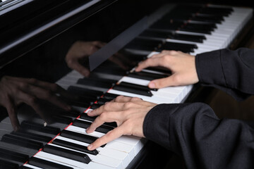 Obraz premium Musician playing piano indoors, closeup. Musical instrument