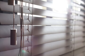Window with closed blinds indoors, closeup view