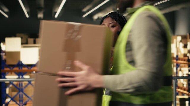 Black worker using headset to provide package tracking status for cargo updates. Woman monitoring airway bill numbers and barcodes for order fulfillment on platform, express delivery.