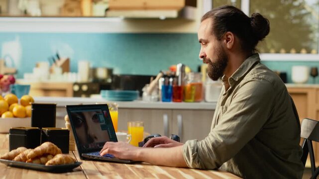 Photographer editor developing photos from recent photo shoot, editing process includes raw image processing, color grading and saturation adjustment. Creative process with graphic design skills.