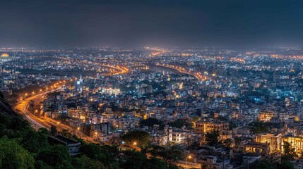 Fototapeta premium Nighttime Cityscape with Illuminated Roads and Buildings Overlook