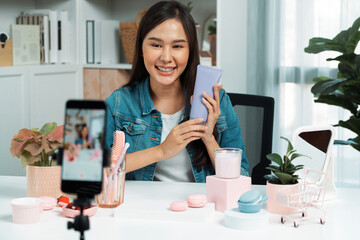 Young beautiful Asian girl reviewing moisturizing body lotion cream product to make glow skin...