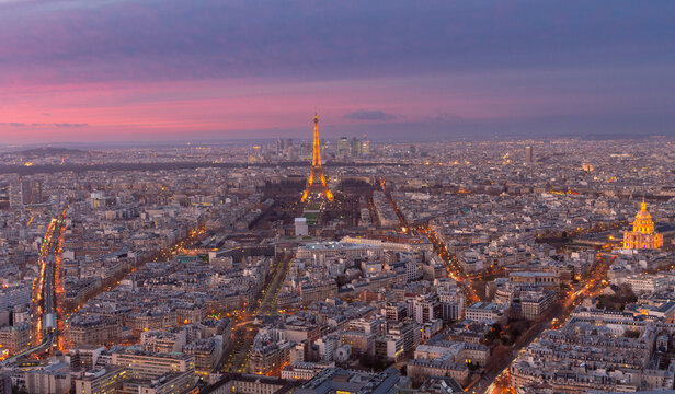 Panoramic aerial view of Paris city at sunset with glowing skyline