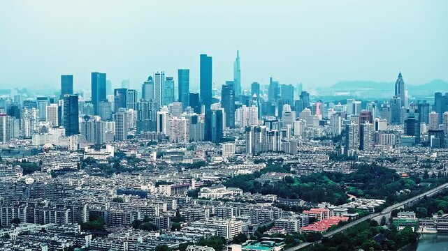 Panoramic aerial view of Nanjing city skyline featuring Zifeng Tower and modern business district architecture in Jiangsu province, China.