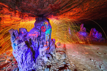 Steel Wool Sparks and Black Light on Cave Formations with Graffiti Art in Vibrant Colors