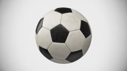 Fototapeta premium Classic black and white stitched soccer ball isolated against a clean, bright, light gray studio background for sports media usage.