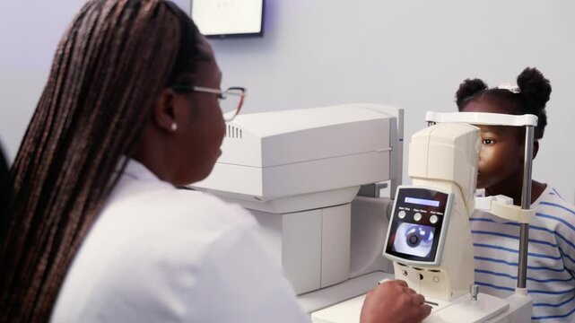 African Optometrist examining a child's eye using a non-contact tonometer (NCT) in a modern clinic