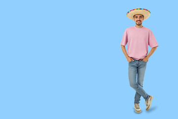 Obraz premium Cinco de Mayo, Young man wears a sombrero and stands with a smile