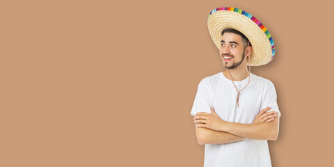 Obraz premium Cinco de Mayo, Young man in sombrero smiles and poses for celebration