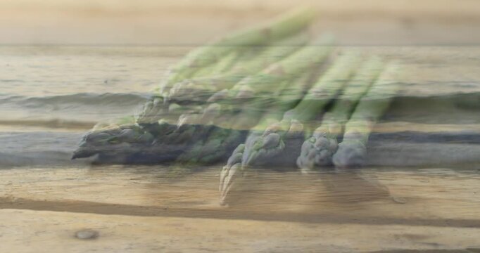 Green asparagus shifting diagonal on play revealing ghosting and clear tips on plank for culinary