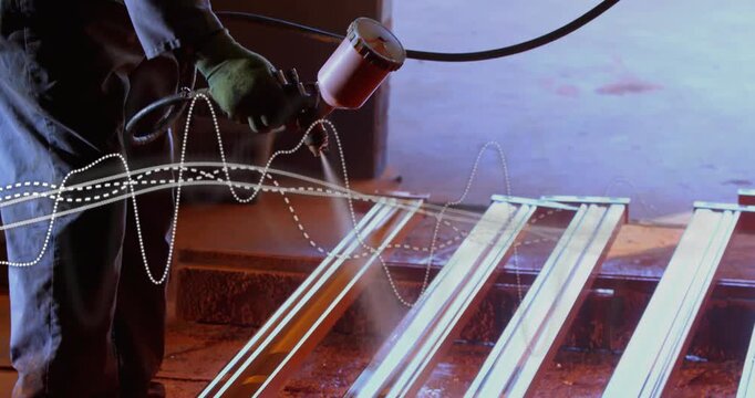 Worker placing hose coating rails sweeping spray gun for finish while dotted waveform crosses frame