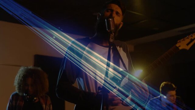 Camera moving forward reframing lead singer showcasing vocals, blue lens flare highlighting guitar