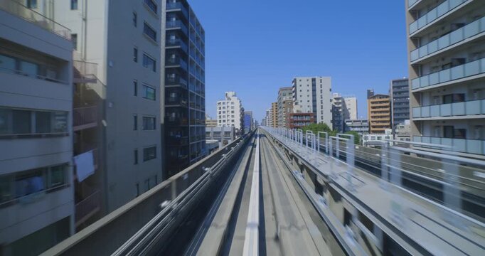 A hyper lapse of a moving forward urban monorail at the downtown in Tokyo by POV