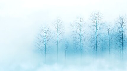 Obraz premium Ethereal Winter Landscape with Fog and Bare Trees in Soft Blue Hues for Tranquil Atmosphere