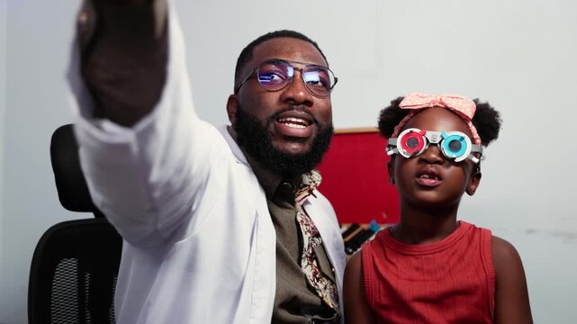African Optometrist helping child during eye examination with trial frame