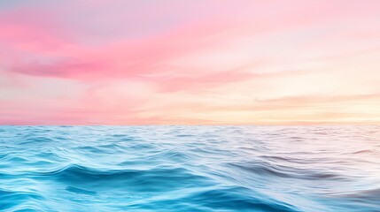 Obraz premium Serene Ocean Waves Under Colorful Sunset Sky with Soft Pink and Blue Tones