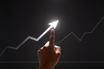 Hand pointing at upward arrow on graph