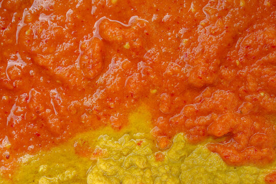 the texture of a traditional spice paste, consisting of a mixture of turmeric, onion, and ground red chilies