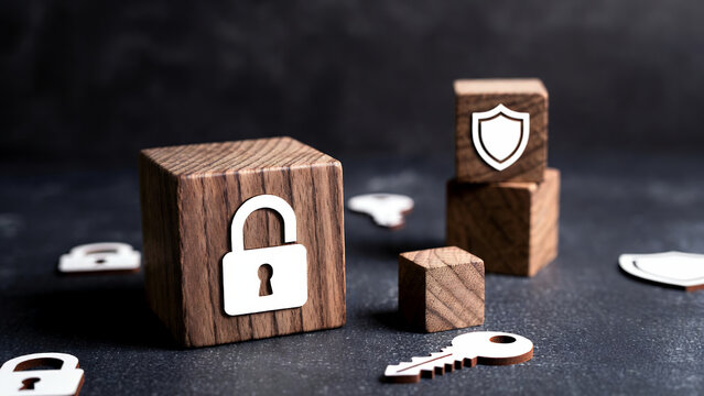 Wooden blocks featuring security lock and shield symbols represent digital data protection.