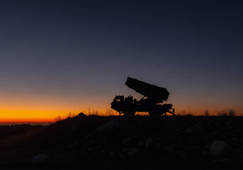 Fototapeta premium Silhouette of Military Rocket Launcher at Beautiful Sunset Landscape Scenery