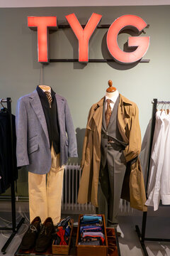 Stockholm, Sweden Men's fashion in the interior of a second-hand clothing store, and a sign in Swedish saying Tyg, or fabric.