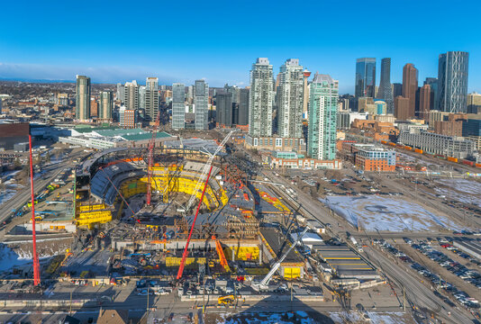 Calgary, Alberta, Canada. March 11, 2026. High-angle view of the new Scotia Place arena under construction with the city skyline in the background. A major stadium construction site 