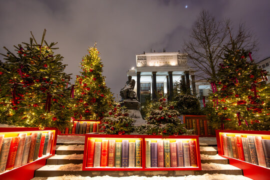Russian State Library, Moscow, Russia &ndash; December 29, 2025. Text on the building: "State Library of the USSR named after Lenin." A winter evening cityscape with Christmas trees and decorative books.