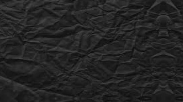 Animated black crumpled paper texture unfolding