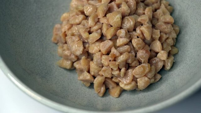 Close-up movie of crushed natto (fermented soybeans) in a Japanese dish in Japan at 60fps