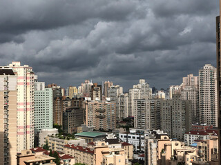 Fototapeta premium Heavy gray overcast skies low over the skyscrapers of Shanghai
