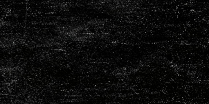 Macro texture of rain drops on a dark black stone surface creates a rough pattern backdrop for a textured wallpaper design