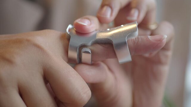 Hand Wearing a Metal Finger Splint