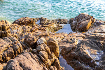 Obraz premium Kalim Beach seascape blue turquoise clear water waves rocks Thailand.