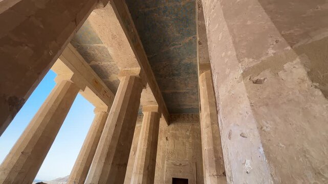 Low angle view of the beautifully preserved blue astronomical ceiling with stars and monumental white columns inside the Temple of Hatshepsut in Egypt