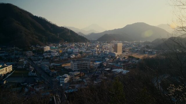 Urban view of Otsuki town with Mount Fuji dominating the horizon.