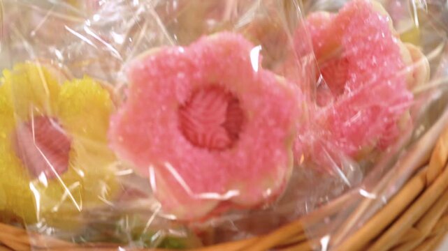 Hand Holding Green Sugar Cookie in Clear Wrap