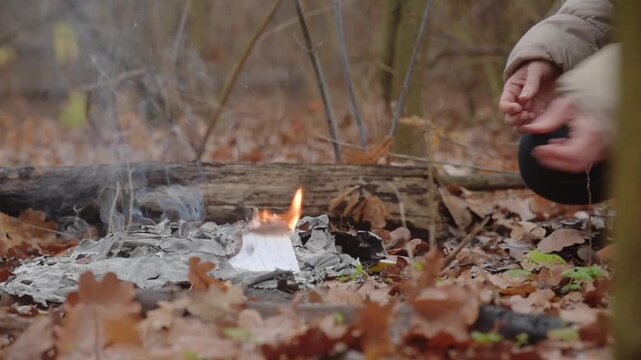 Closeup photo of woman burning important documents on fire to hide the truth Woman tearing and burning confidential pages outdoors, removing sensitive information and secrets