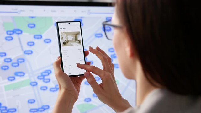 Real Estate Agent Carefully Searches Property Listings Online Using Computer