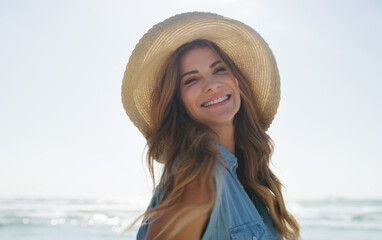 Portrait, woman or smile on holiday at beach for summer vacation, weekend break or getaway trip. Space, sunshine or happy person with hat at seaside for travel adventure, fresh air or tropical island