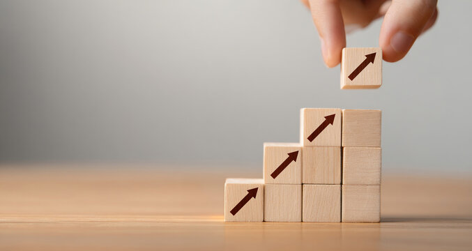 Close up woman hand arranging wood block stacking as step stair on paper blue background. Business concept growth success process with copy space