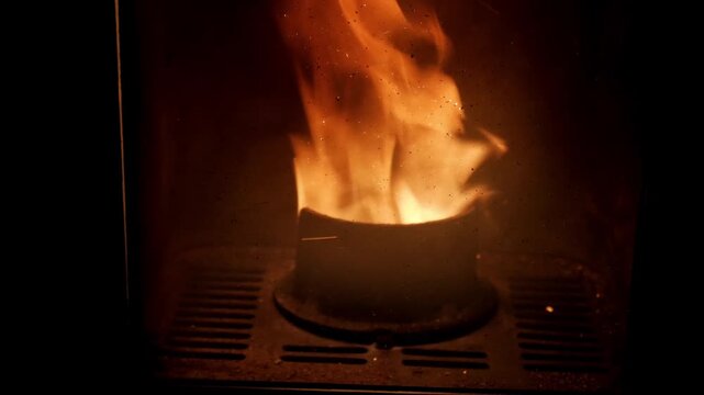 Warm flames flicker in a pellet stove, cozy indoor atmosphere
