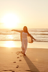 Sunset, portrait and woman with freedom on beach for travel adventure, weekend trip or fresh air. Evening, person and relax on sand for getaway break, tropical vacation and holiday with mockup space